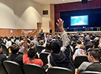  students raise their hands during Autism Speaks presentation
